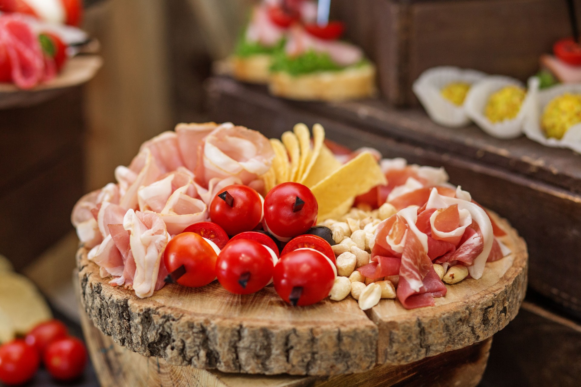 Food at event. Gourmet Charcuterie Platter on Wooden Board